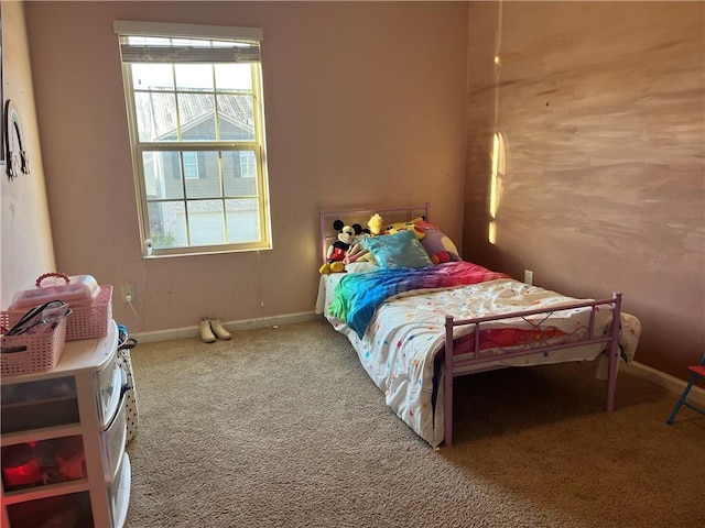 bedroom with multiple windows, baseboards, and carpet