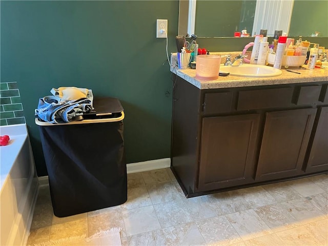 bathroom with vanity and baseboards