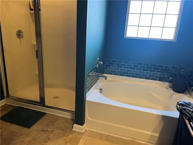 bathroom with a shower stall and a bath