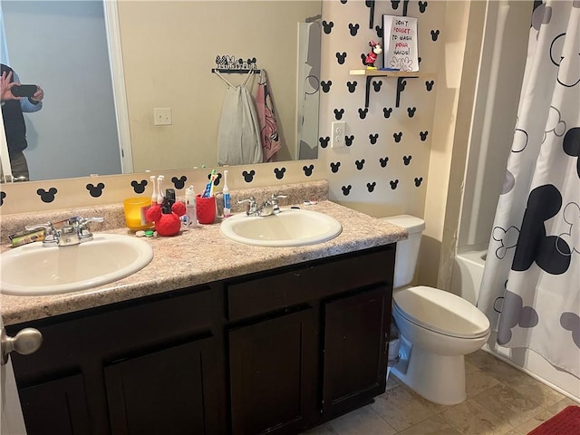 full bath featuring double vanity, shower / bathtub combination with curtain, toilet, and a sink