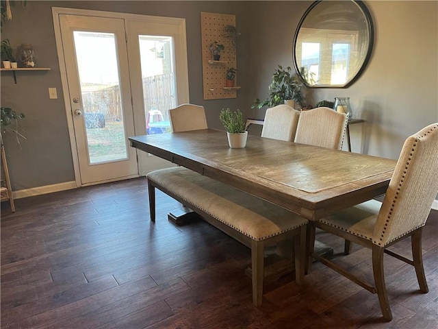 dining area featuring dark wood finished floors and baseboards