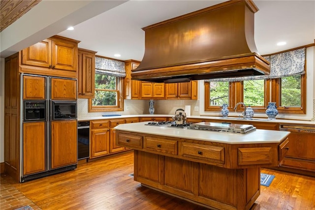44 Muscogee Ave NW, Atlanta, GA 30305 - kitchen featuring paneled appliances, premium range hood, brown cabinetry, crown molding, and recessed lighting
