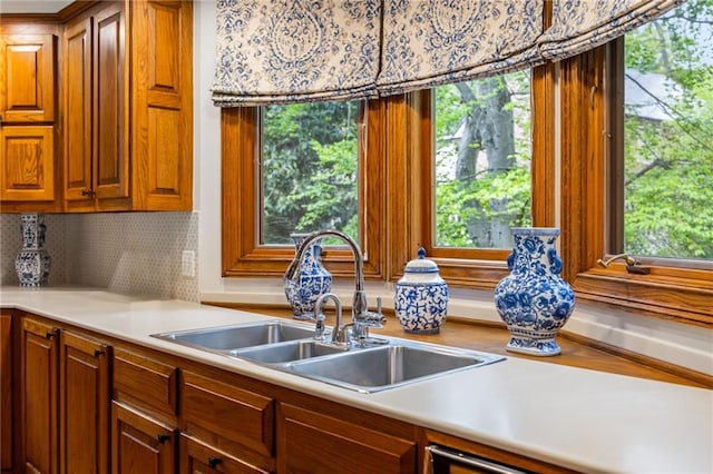 44 Muscogee Ave NW, Atlanta, GA 30305 - kitchen with a sink, tasteful backsplash, light countertops, and brown cabinets