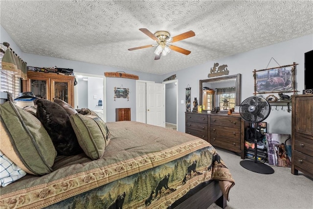 bedroom featuring a textured ceiling, carpet floors, multiple windows, and a ceiling fan