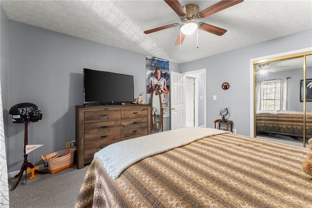 carpeted bedroom with a closet, ceiling fan, and a textured ceiling