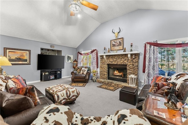 living area featuring baseboards, a ceiling fan, vaulted ceiling, carpet floors, and a fireplace