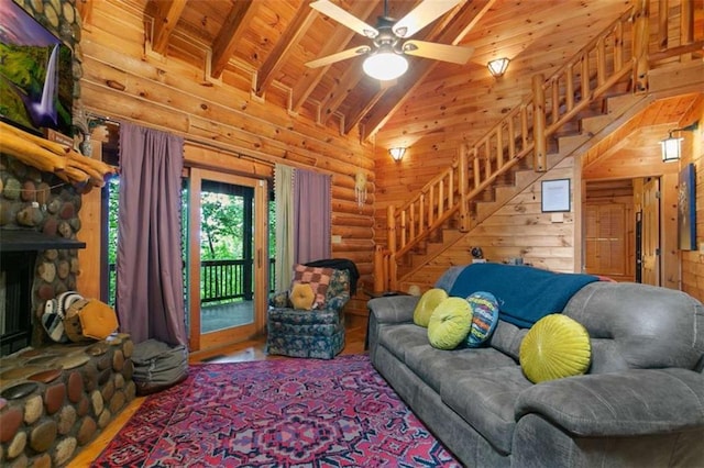 living room featuring a stone fireplace, rustic walls, high vaulted ceiling, wooden ceiling, and beamed ceiling