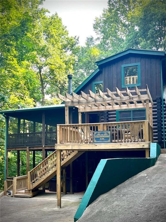 exterior space with a wooden deck and a pergola