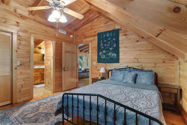 bedroom featuring ceiling fan, wooden walls, and lofted ceiling with beams