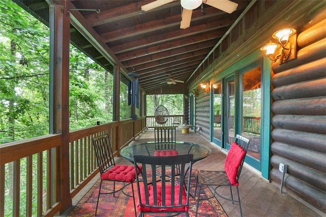 sunroom / solarium featuring ceiling fan and vaulted ceiling