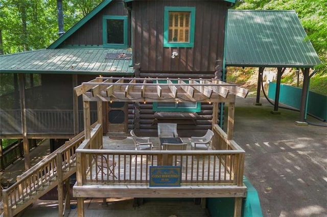 back of house featuring a wooden deck and a patio area