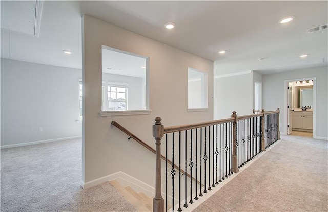 hall featuring recessed lighting, carpet floors, an upstairs landing, baseboards, and attic access