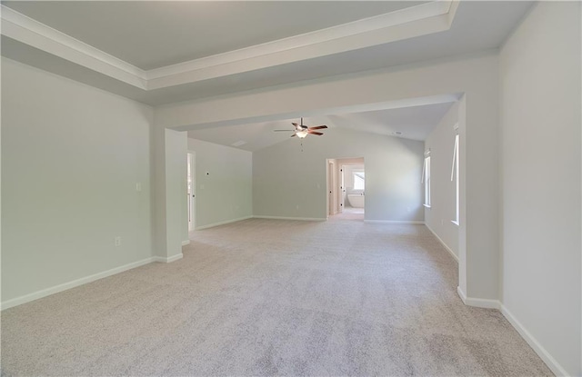 unfurnished room with a ceiling fan, lofted ceiling, light colored carpet, and baseboards