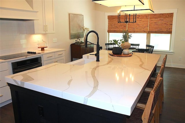 688 Harmony Rd, Temple, GA 30179 - kitchen featuring premium range hood, black appliances, a spacious island, dark wood-style flooring, and healthy amount of natural light