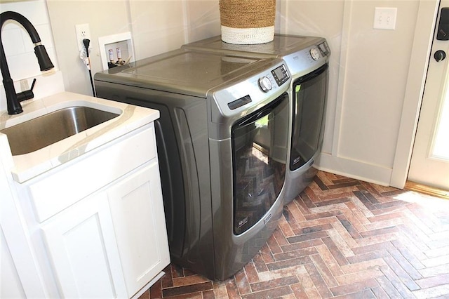 688 Harmony Rd, Temple, GA 30179 - laundry room with washer and clothes dryer, cabinet space, and brick flooring