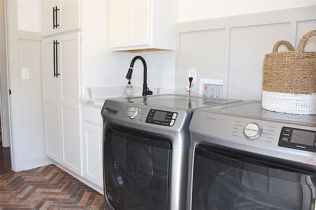 688 Harmony Rd, Temple, GA 30179 - washroom featuring separate washer and dryer, cabinet space, and brick flooring