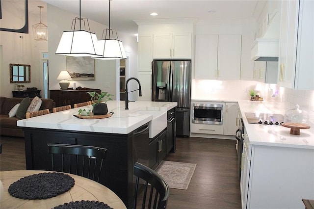 688 Harmony Rd, Temple, GA 30179 - kitchen with dark wood-style flooring, stainless steel appliances, white cabinetry, dark cabinetry, and hanging light fixtures
