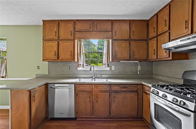 140 Carriage Cir, Stockbridge, GA 30281 - kitchen featuring stainless steel appliances, extractor fan, a peninsula, dark wood-type flooring, and a textured ceiling