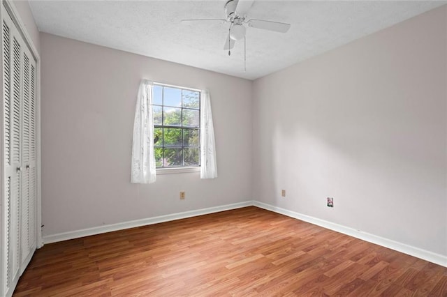 140 Carriage Cir, Stockbridge, GA 30281 - unfurnished bedroom featuring light wood-style flooring, a closet, a textured ceiling, and a ceiling fan