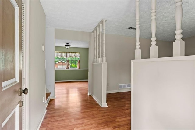 140 Carriage Cir, Stockbridge, GA 30281 - hall with wood finished floors and a textured ceiling