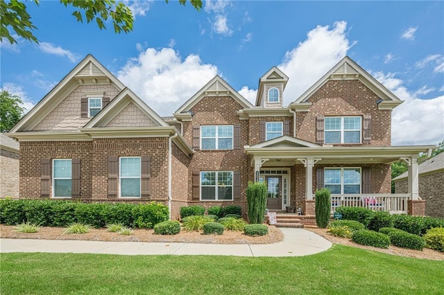 5515 Cheatam Ave, Cumming, GA 30040 - craftsman inspired home with brick siding, a front lawn, and covered porch