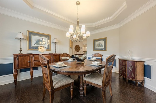 5515 Cheatam Ave, Cumming, GA 30040 - dining room with a chandelier, dark wood-type flooring, a tray ceiling, ornamental molding, and a wainscoted wall