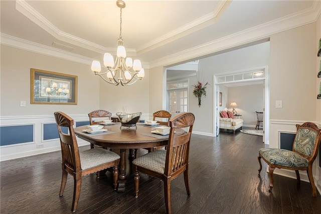 5515 Cheatam Ave, Cumming, GA 30040 - dining area featuring dark wood-type flooring, a chandelier, a raised ceiling, and crown molding