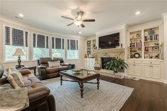5515 Cheatam Ave, Cumming, GA 30040 - living area with ceiling fan, dark wood-style floors, crown molding, a stone fireplace, and built in features