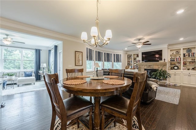 5515 Cheatam Ave, Cumming, GA 30040 - dining area with a ceiling fan, dark wood-style flooring, ornamental molding, a stone fireplace, and a chandelier