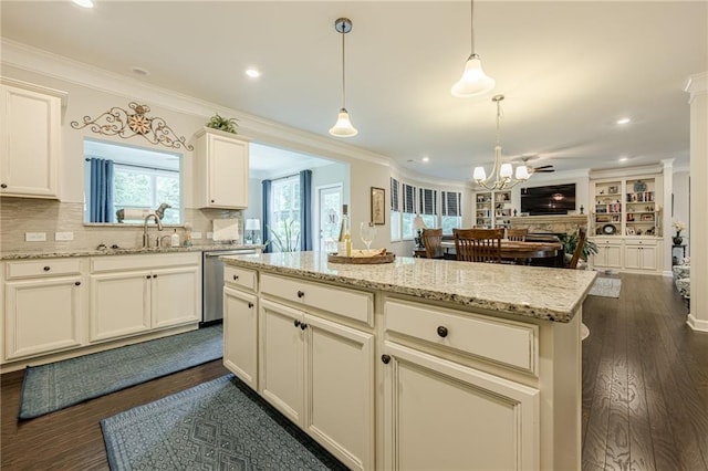 5515 Cheatam Ave, Cumming, GA 30040 - kitchen with dishwasher, open floor plan, a kitchen island, decorative light fixtures, and backsplash
