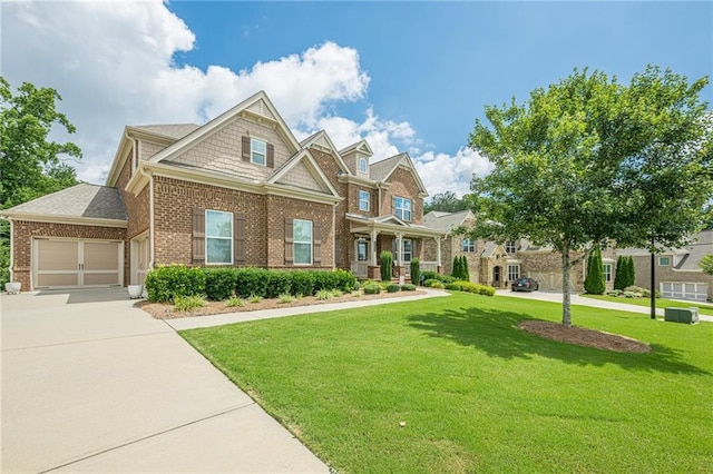 5515 Cheatam Ave, Cumming, GA 30040 - craftsman-style house featuring brick siding, a front lawn, driveway, and a garage