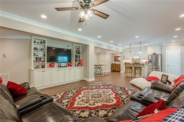 5515 Cheatam Ave, Cumming, GA 30040 - living room featuring wood finished floors, ceiling fan, crown molding, and recessed lighting