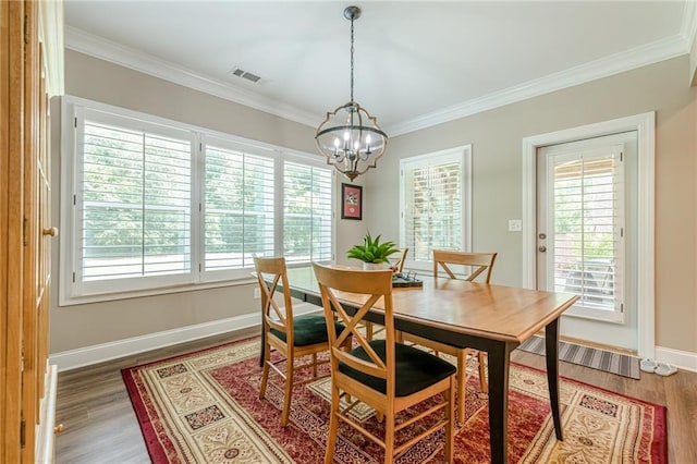 5515 Cheatam Ave, Cumming, GA 30040 - dining area featuring a chandelier, crown molding, and wood finished floors