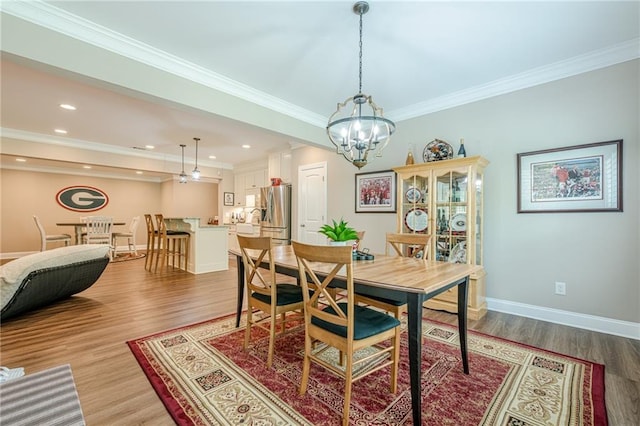 5515 Cheatam Ave, Cumming, GA 30040 - dining area featuring light wood finished floors, a chandelier, crown molding, and recessed lighting