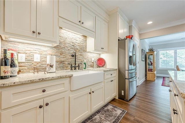 5515 Cheatam Ave, Cumming, GA 30040 - kitchen with stainless steel refrigerator with ice dispenser, crown molding, wood finished floors, backsplash, and white cabinets