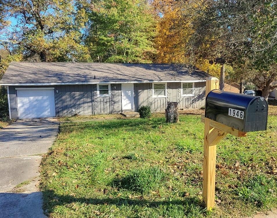 1946 Singer Way, Lithonia, GA 30058 - ranch-style home with driveway and an attached garage