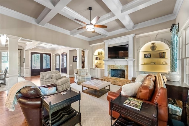 341 Carl Sanders Dr, Acworth, GA 30101 - living room featuring ornate columns, ceiling fan, coffered ceiling, beamed ceiling, and a stone fireplace