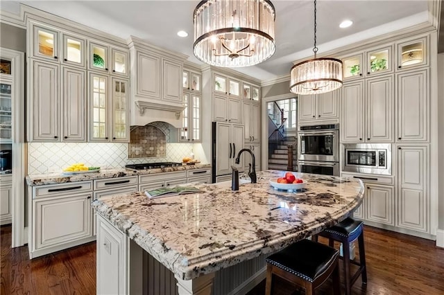 341 Carl Sanders Dr, Acworth, GA 30101 - kitchen with built in appliances, a chandelier, a breakfast bar, dark wood-type flooring, and recessed lighting