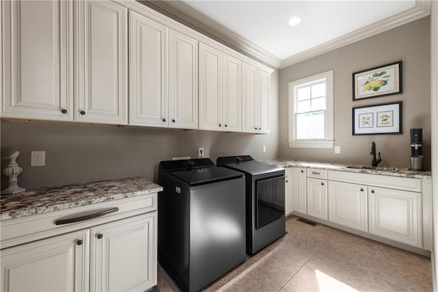 341 Carl Sanders Dr, Acworth, GA 30101 - laundry area with cabinet space, washing machine and clothes dryer, ornamental molding, and light tile patterned flooring