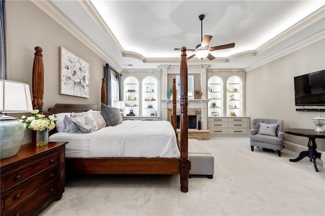 341 Carl Sanders Dr, Acworth, GA 30101 - carpeted bedroom featuring ornamental molding, a stone fireplace, a raised ceiling, and ceiling fan