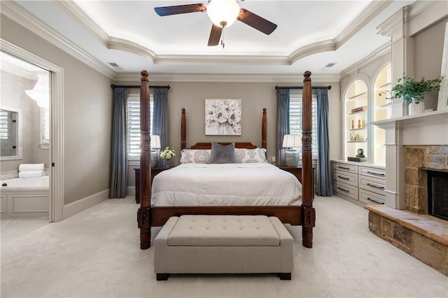 341 Carl Sanders Dr, Acworth, GA 30101 - bedroom with light colored carpet, ornamental molding, a fireplace, a tray ceiling, and connected bathroom