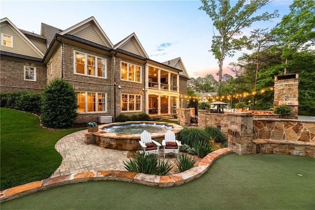 341 Carl Sanders Dr, Acworth, GA 30101 - back of house with a putting green, brick siding, a balcony, and a patio