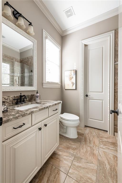 341 Carl Sanders Dr, Acworth, GA 30101 - full bath featuring ornamental molding, vanity, a tile shower, and marble finish flooring