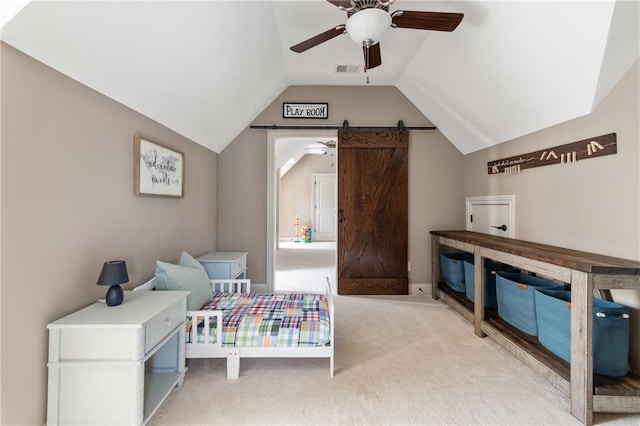 341 Carl Sanders Dr, Acworth, GA 30101 - bedroom with light colored carpet, vaulted ceiling, a barn door, and a ceiling fan