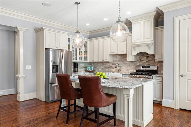 341 Carl Sanders Dr, Acworth, GA 30101 - kitchen featuring appliances with stainless steel finishes, a kitchen island, backsplash, dark wood-type flooring, and ornamental molding