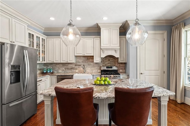 341 Carl Sanders Dr, Acworth, GA 30101 - kitchen featuring appliances with stainless steel finishes, dark wood-style flooring, tasteful backsplash, glass insert cabinets, and a breakfast bar area
