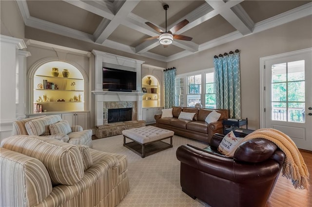 341 Carl Sanders Dr, Acworth, GA 30101 - living area with ceiling fan, a stone fireplace, beam ceiling, coffered ceiling, and built in shelves