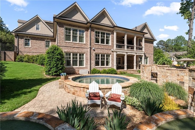 341 Carl Sanders Dr, Acworth, GA 30101 - back of property featuring a balcony, brick siding, a yard, and a patio