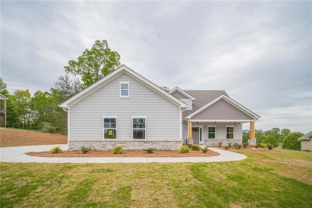 view of front of property featuring covered porch and a front lawn