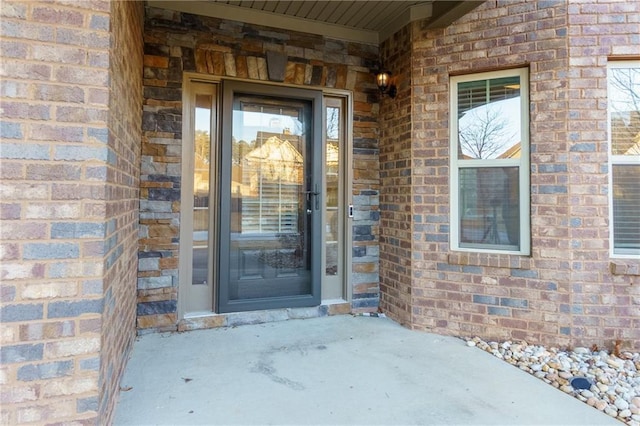 doorway to property with brick siding